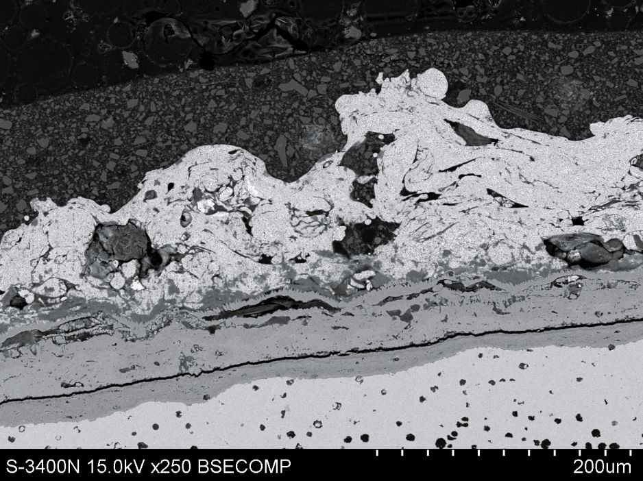 Rys. 3. Przykładowe zdjęcie z mikroskopu, na którym pokazano warstewkę produktów korozji pod ocynkiem [17]